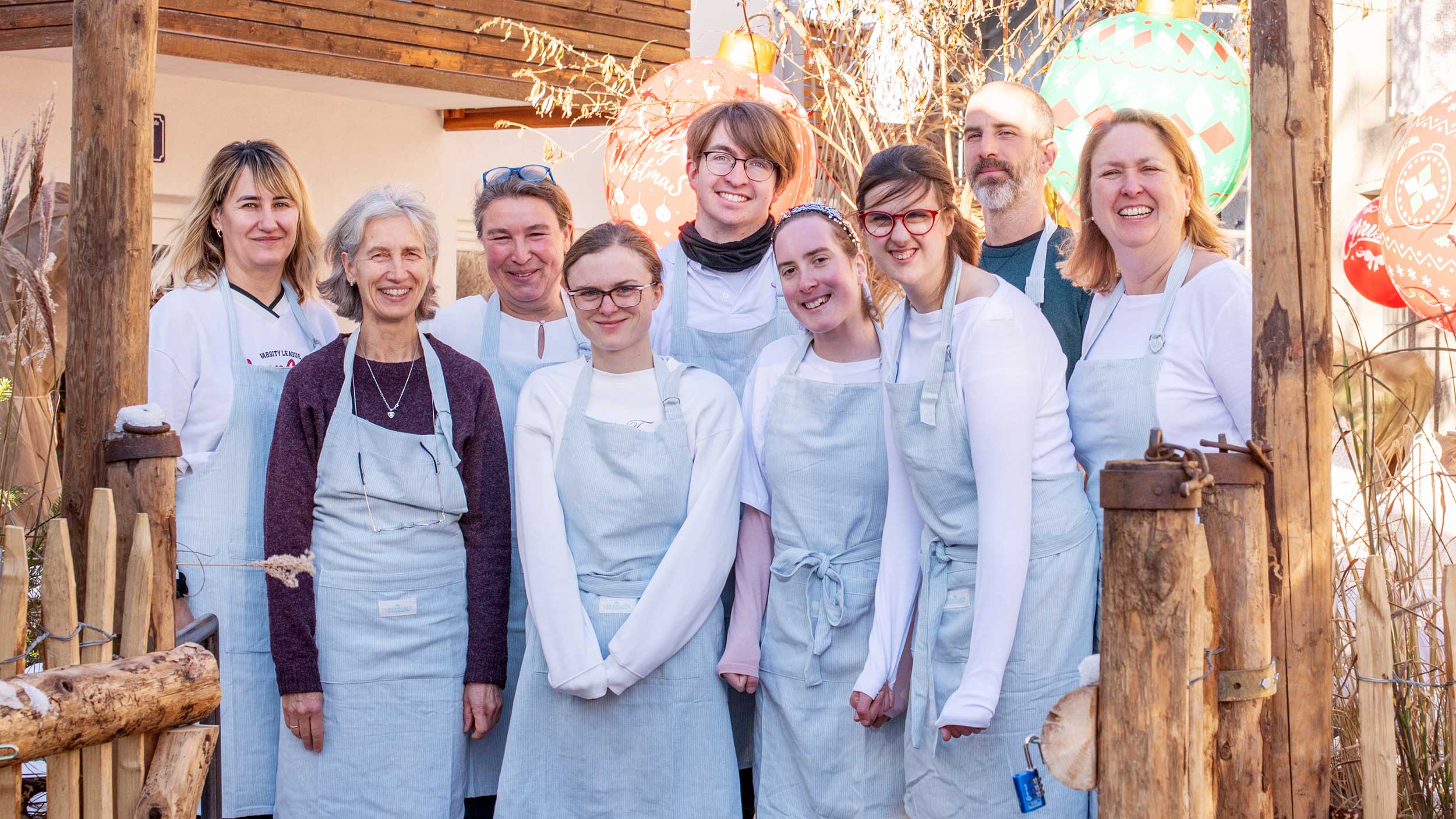 CafeMiteinand-Team-060_16-9 Das Team des Cafe Miteinand lacht in die Kamera